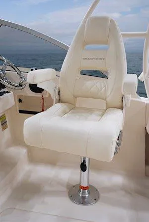 Slide: The Image of Luxury captain's chair on 2025 Grady-White Freedom 235 boat, featuring plush white upholstery. - 18