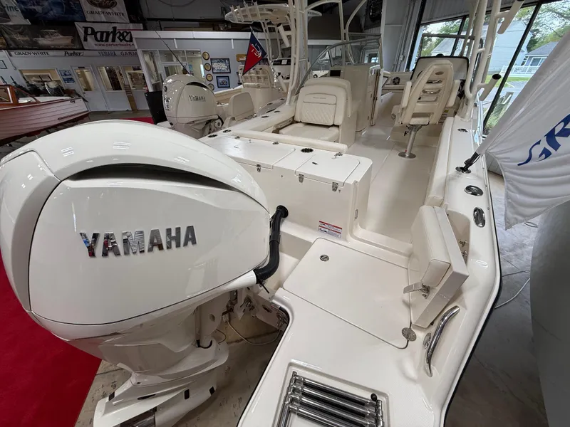 Slide: The Image of 2025 Grady-White Freedom 235 boat with Yamaha engine in showroom. - 2