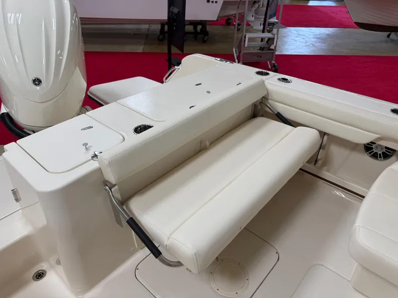 Slide: The Image of 2025 Grady-White Freedom 235 boat interior with white seating and storage compartments. - 22
