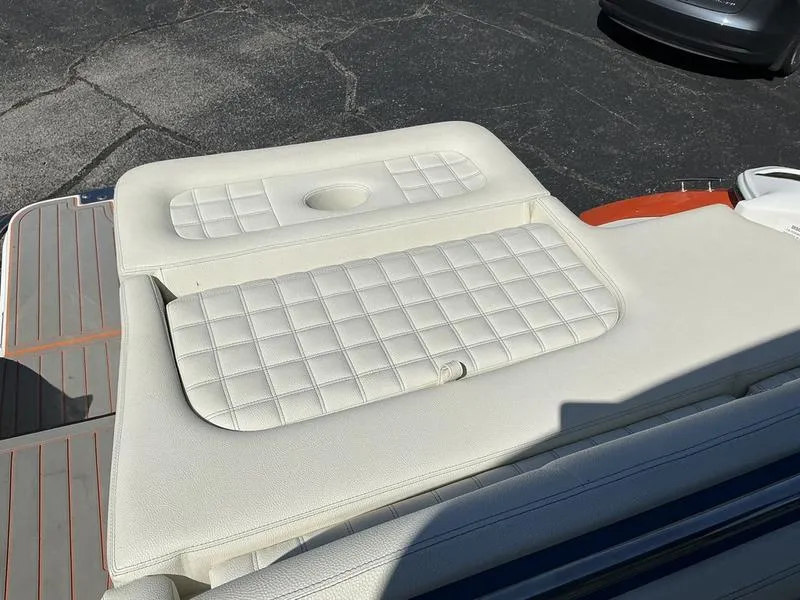 Slide: The Image of 2021 Cobalt R7 Surf boat with white cushioned seating and textured design. - 10