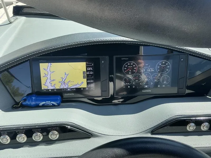 Slide: The Image of Dashboard of a 2021 Cobalt R7 Surf boat with Garmin navigation displays. - 12