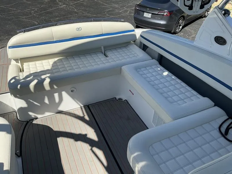 Slide: The Image of 2021 Cobalt R7 Surf boat interior with white cushioned seating and blue accents. - 5