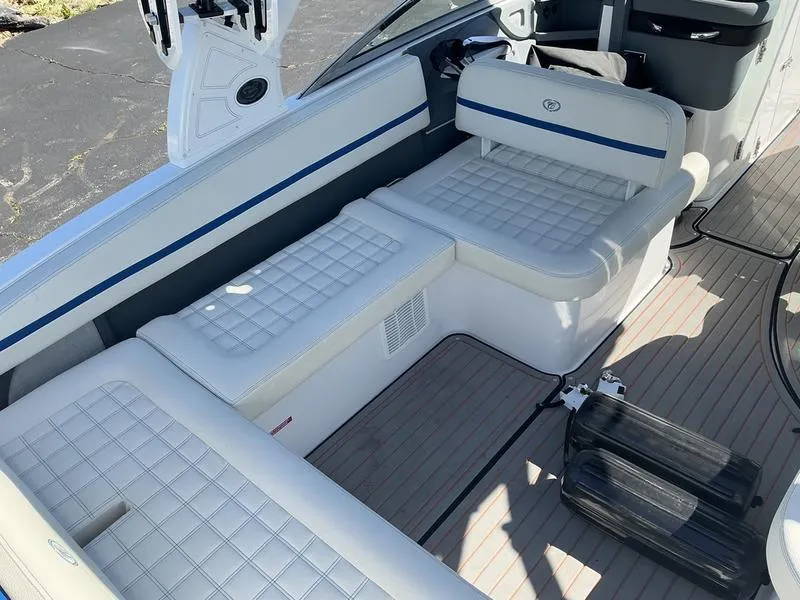 Slide: The Image of 2021 Cobalt R7 Surf boat interior with white cushioned seating and sleek design. - 7