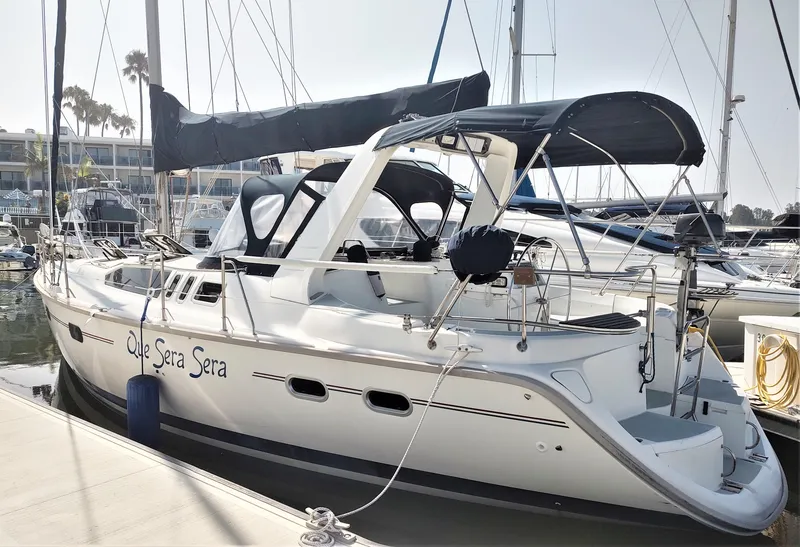 The Image of Sailboat Hunter 430, 1995 model, docked at marina with "Que Sera Sera" on hull. - 0