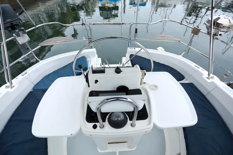 Slide: The Image of Cockpit view of a 1995 Hunter 430 sailboat with steering wheel and navigation equipment. - 11