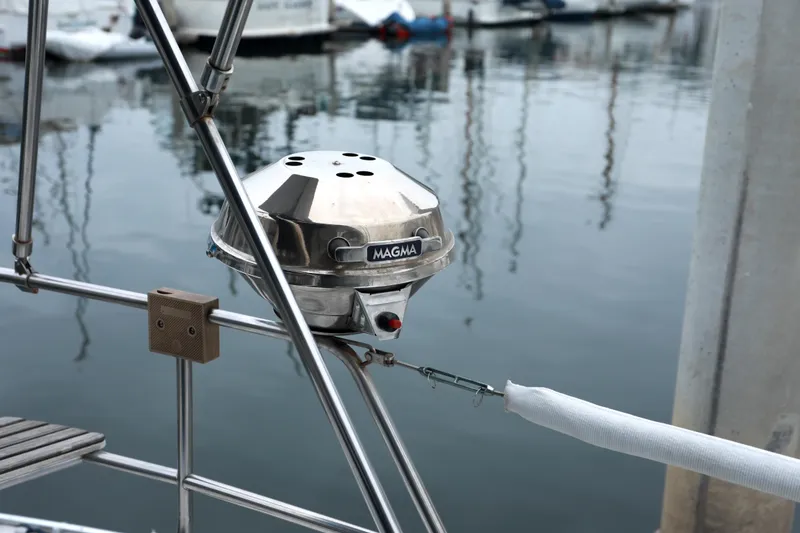 Slide: The Image of Stainless steel grill on a 1995 Hunter 430 sailboat, docked at a marina. - 12