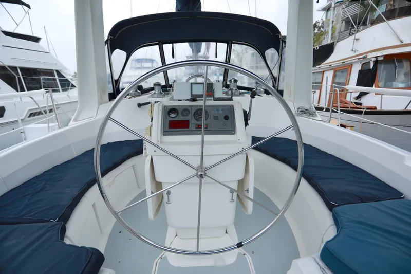 Slide: The Image of Cockpit of 1995 Hunter 430 sailboat with steering wheel and navigation instruments. - 13