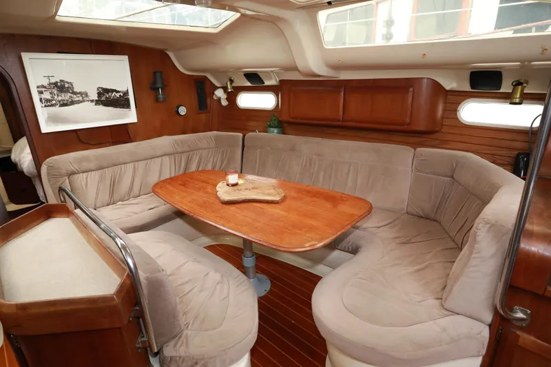 Slide: The Image of Cozy interior of 1995 Hunter 430 yacht with plush seating and wooden table. - 19