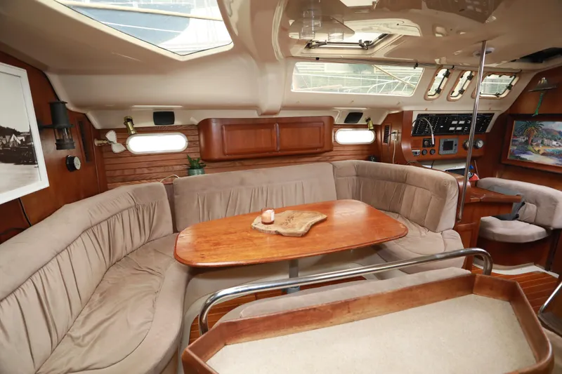 Slide: The Image of Interior of a 1995 Hunter 430 yacht with cozy seating and wooden accents. - 20