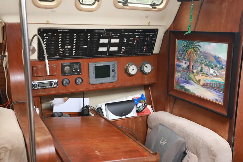 Slide: The Image of Interior of 1995 Hunter 430 sailboat with navigation panel and colorful wall art. - 26