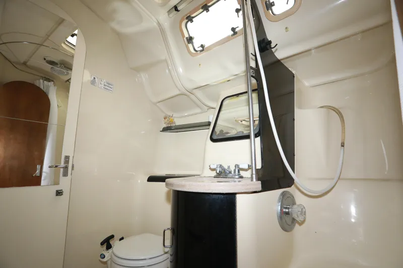 Slide: The Image of Bathroom interior of a 1995 Hunter 430 yacht, featuring a toilet, sink, and shower. - 30