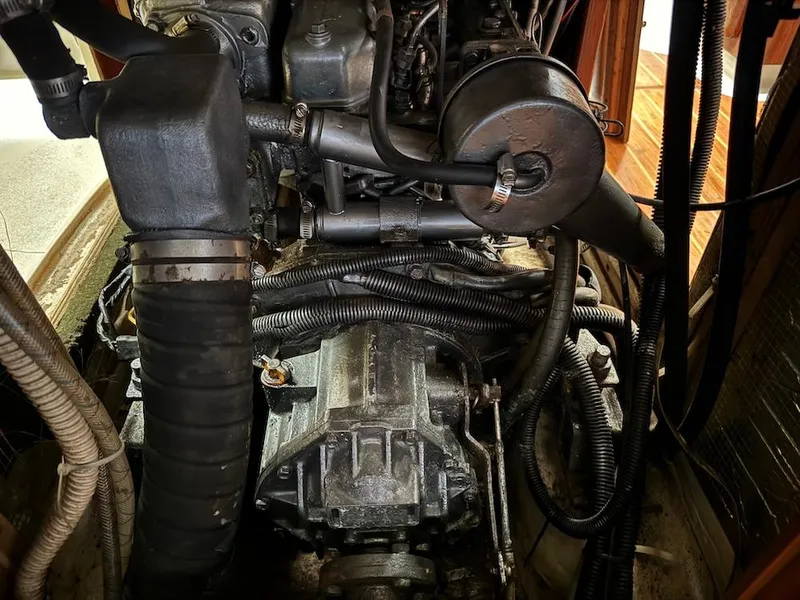 Slide: The Image of Engine compartment of a 1995 Hunter 430 sailboat, showing mechanical components and wiring. - 38