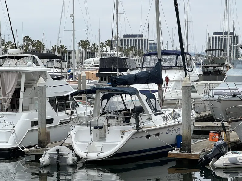 Slide: The Image of Sailboats docked at a marina, featuring a 1995 Hunter 430 model. - 4