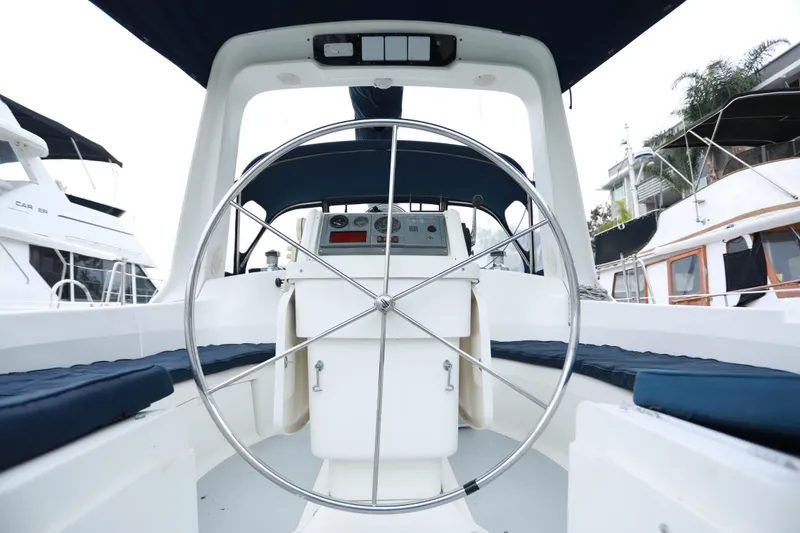 Slide: The Image of Cockpit view of a 1995 Hunter 430 sailboat with a large steering wheel. - 9