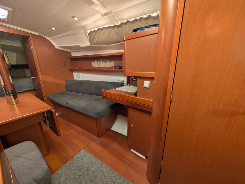 Slide: The Image of Interior of 2015 Beneteau Oceanis 37 Platinum yacht with wooden finish and cozy seating. - 18