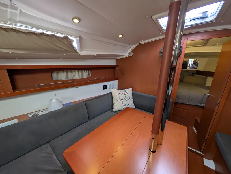 Slide: The Image of Interior of 2015 Beneteau Oceanis 37 Platinum sailboat, featuring cozy seating and wooden table. - 19