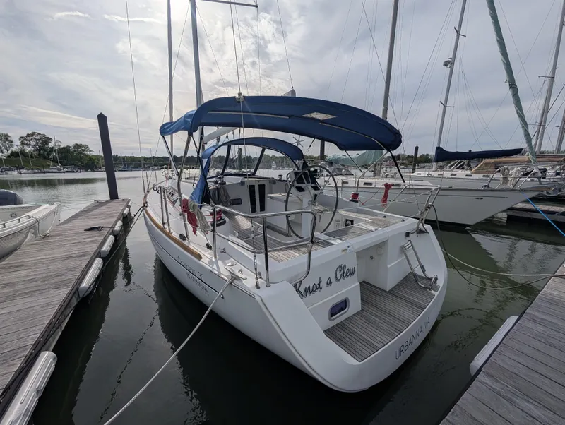 Slide: The Image of 2015 Beneteau Oceanis 37 Platinum sailboat docked at marina, rear view. - 2