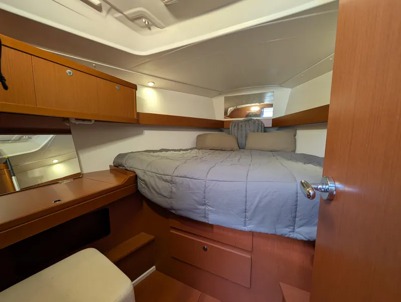 Slide: The Image of 2015 Beneteau Oceanis 37 Platinum cabin with cozy bed and wooden interior. - 21