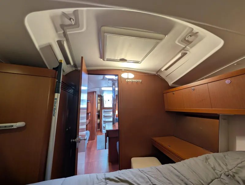 Slide: The Image of Interior of 2015 Beneteau Oceanis 37 Platinum yacht, featuring cozy cabin and wooden furnishings. - 22