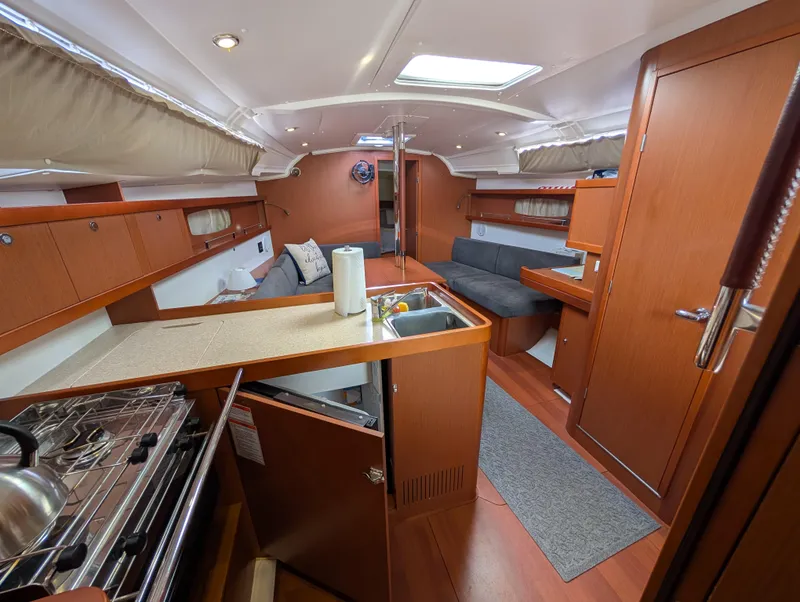 Slide: The Image of Interior of 2015 Beneteau Oceanis 37 Platinum yacht with kitchen and seating area. - 24