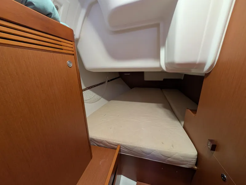 Slide: The Image of 2015 Beneteau Oceanis 37 Platinum cabin interior with wooden finish and cozy bed. - 27