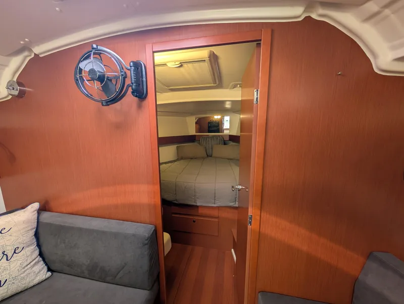 Slide: The Image of Interior of 2015 Beneteau Oceanis 37 Platinum yacht, featuring cozy cabin and seating area. - 28