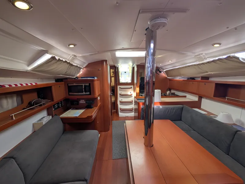 Slide: The Image of Interior of 2015 Beneteau Oceanis 37 Platinum yacht, featuring cozy seating and modern amenities. - 30