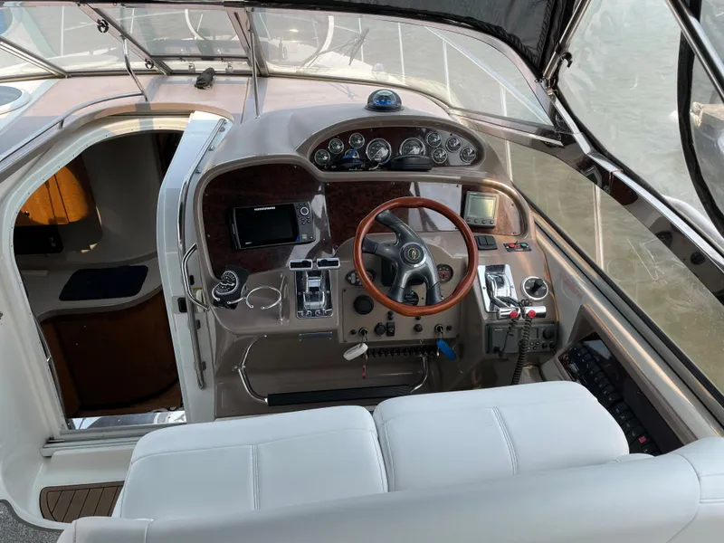 Slide: The Image of Cockpit of 2003 Regal 3860 Commodore yacht with steering wheel and control panel. - 11