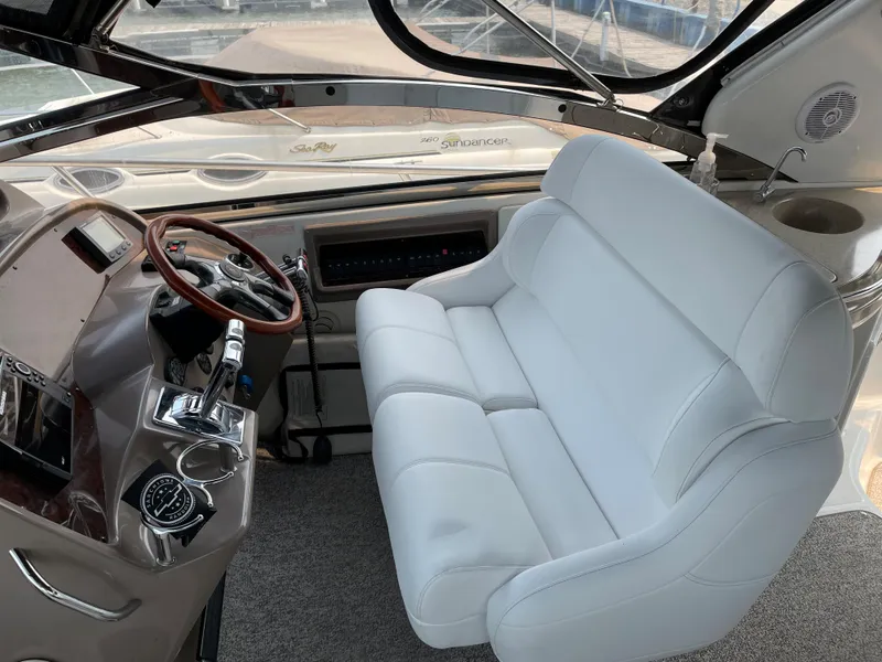 Slide: The Image of 2003 Regal 3860 Commodore helm with white seating and wooden steering wheel. - 12