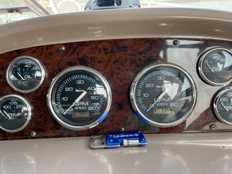Slide: The Image of Dashboard of 2003 Regal 3860 Commodore boat with RPM and oil gauges. - 13