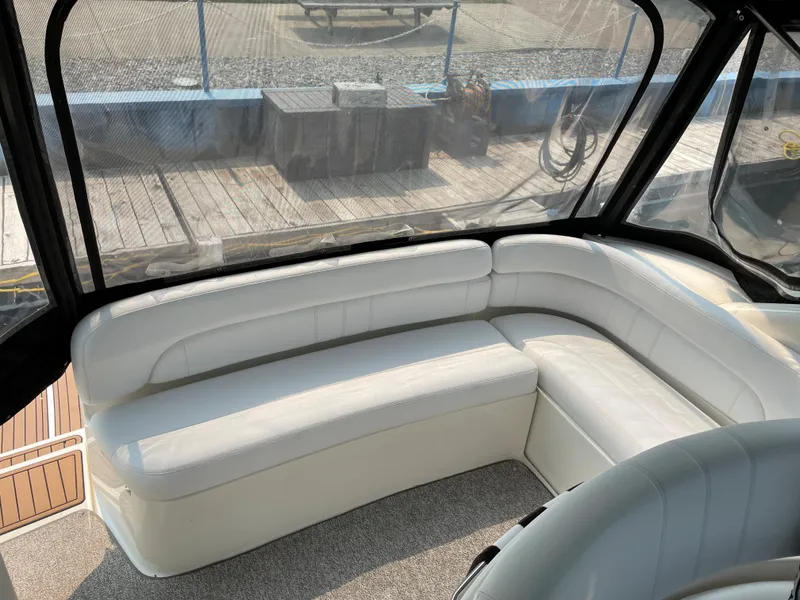 Slide: The Image of 2003 Regal 3860 Commodore boat interior with white leather seating and clear enclosure. - 16