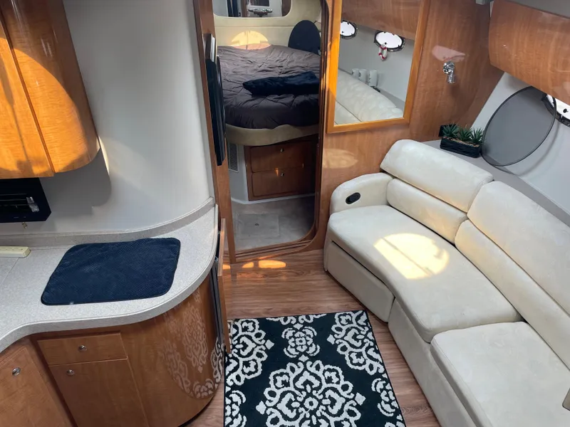 Slide: The Image of Interior of 2003 Regal 3860 Commodore yacht with sofa, kitchenette, and bedroom. - 7