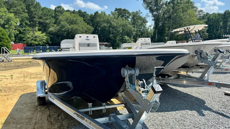 Slide: The Image of 2025 Carolina Skiff 19 LS Stealth Edition boat on trailer, parked outdoors. - 3