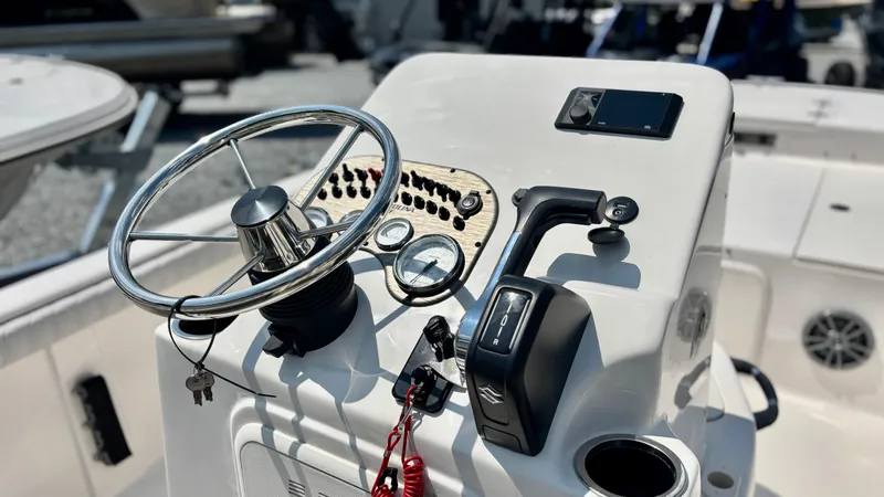 Slide: The Image of 2025 Carolina Skiff 19 LS Stealth Edition helm with steering wheel and controls. - 5