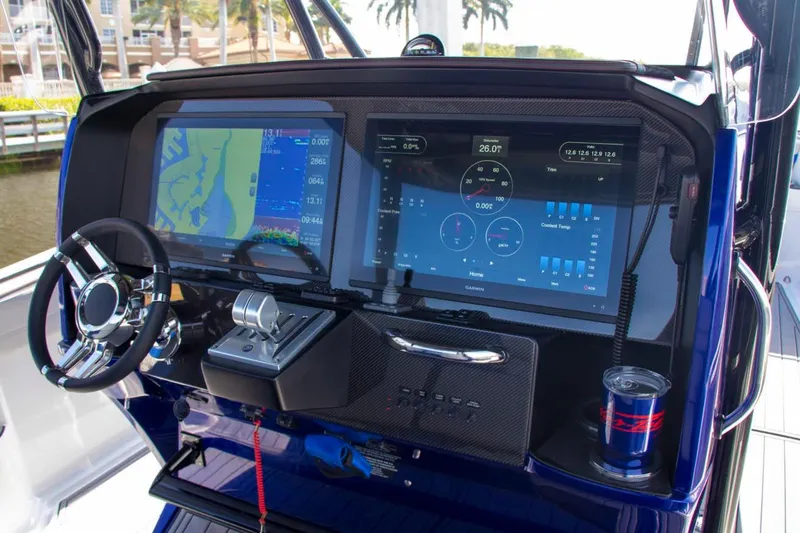 Slide: The Image of 2026 Nor-Tech 390 Sport Center Console boat in a warehouse on a trailer. - 18