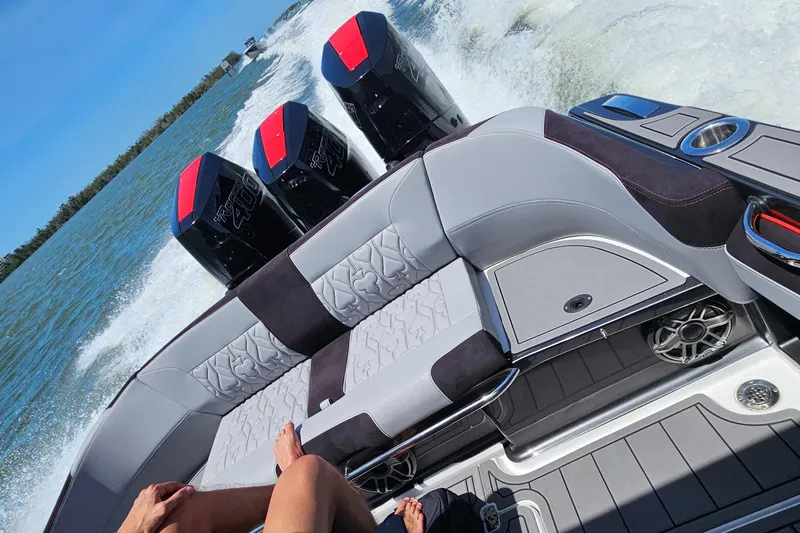 Slide: The Image of 2026 Nor-Tech 390 Sport Center Console boat in a warehouse, on a trailer. - 7