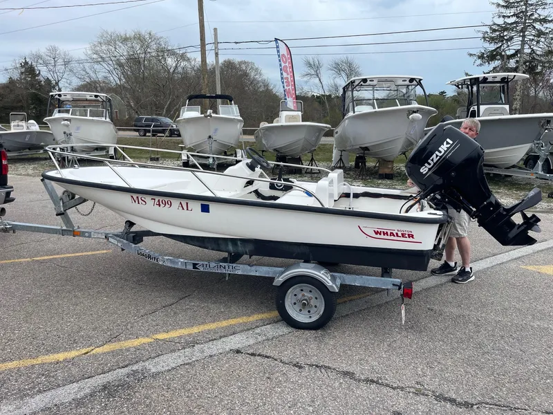 Slide: The Image of 2005 Boston Whaler 150 Sport boat on trailer with Suzuki outboard motor. - 3