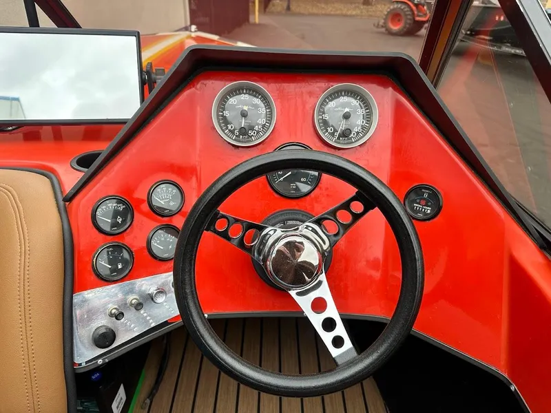 Slide: The Image of 1988 Malibu Skier dashboard with steering wheel and gauges, featuring a vibrant red design. - 15