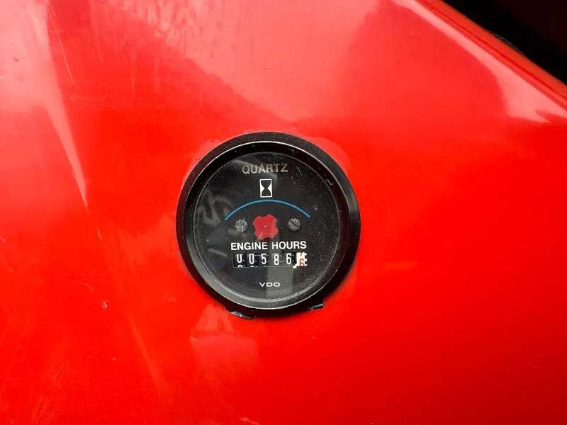 Slide: The Image of 1988 Malibu Skier engine hour meter showing 586 hours on red background. - 17