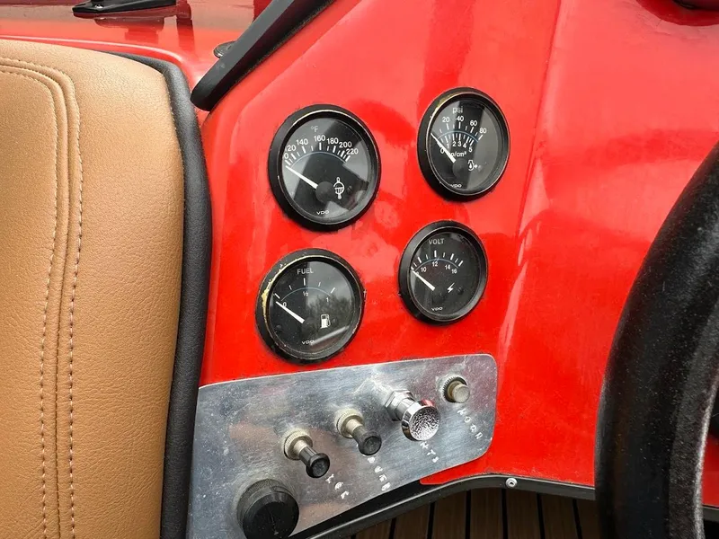 Slide: The Image of 1988 Malibu Skier dashboard with gauges and controls, featuring a red and tan interior. - 18