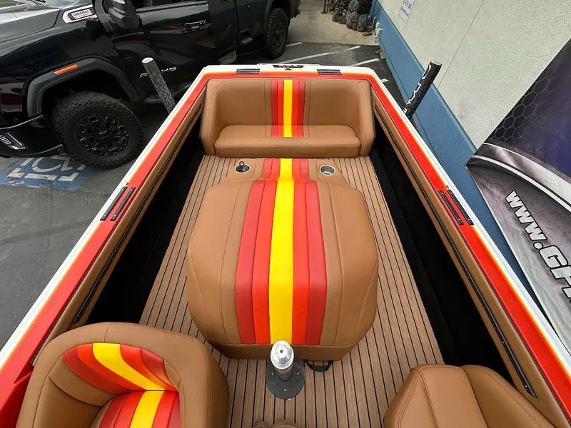 Slide: The Image of 1988 Malibu Skier boat interior with brown, red, and yellow striped seats. - 20