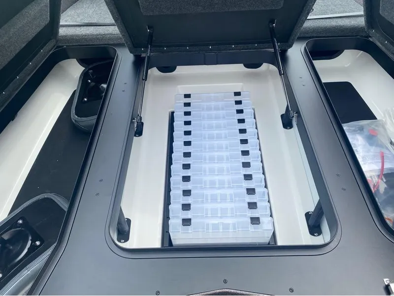 Slide: The Image of Storage compartment of 2025 Skeeter ZXR 21 boat with organized tackle boxes. - 12