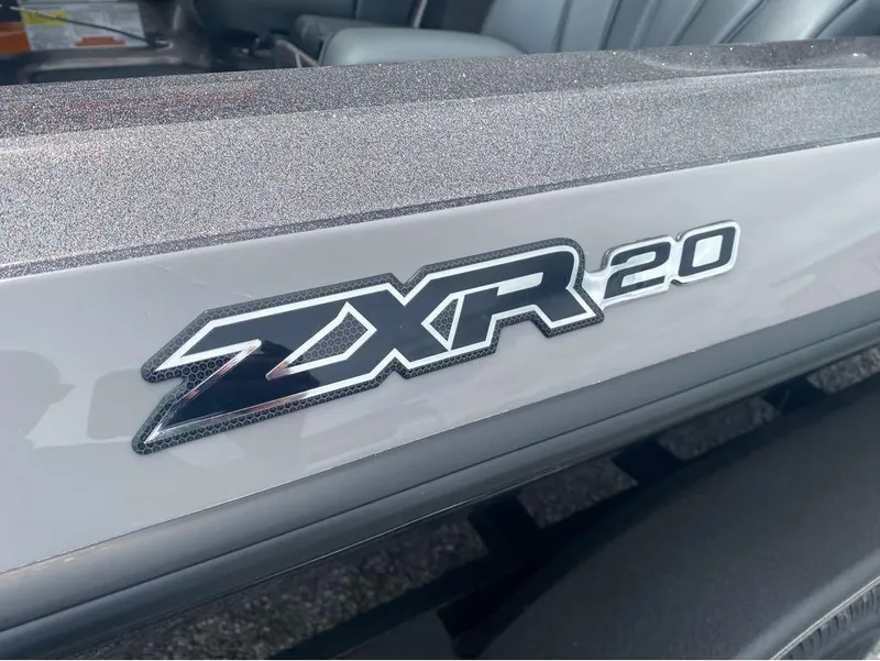 Slide: The Image of Close-up of Skeeter ZXR 20 logo on a sleek surface. - 18