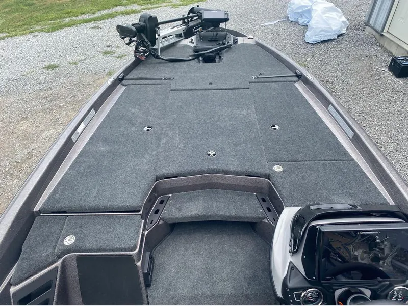 Slide: The Image of 2025 Skeeter ZXR 21 boat interior with gray carpet and advanced control panel. - 20