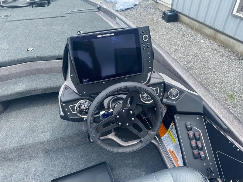 Slide: The Image of 2025 Skeeter ZXR 21 boat dashboard with steering wheel and Humminbird display. - 6