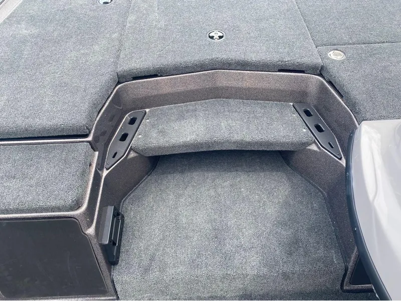 Slide: The Image of 2025 Skeeter ZXR 21 boat deck with gray carpet and storage compartments. - 8