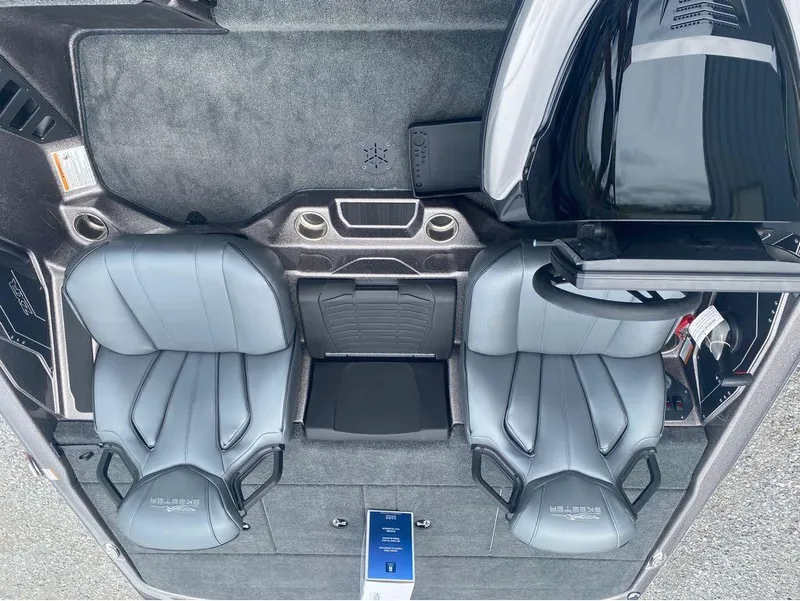 Slide: The Image of 2025 Skeeter ZXR 21 boat interior with dual gray seats and modern dashboard. - 9
