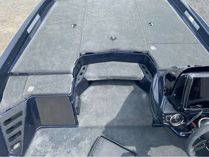 Slide: The Image of 2025 Skeeter ZXR 21 boat interior with carpeted deck and control panel. - 16