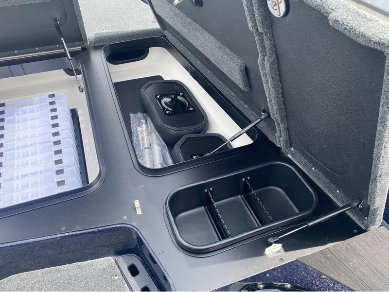 Slide: The Image of 2025 Skeeter ZXR 21 boat storage compartments with organized tackle boxes and equipment. - 17