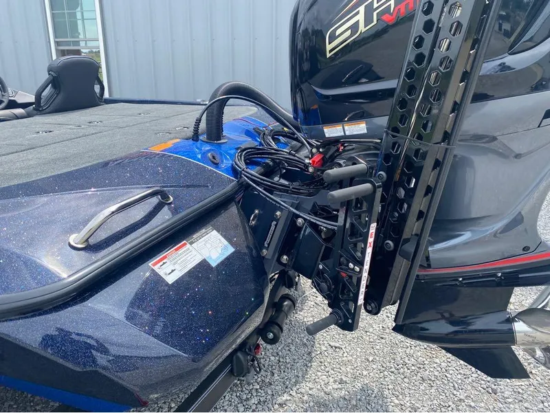 Slide: The Image of 2025 Skeeter ZXR 21 boat with advanced motor and sleek design, parked on gravel. - 5